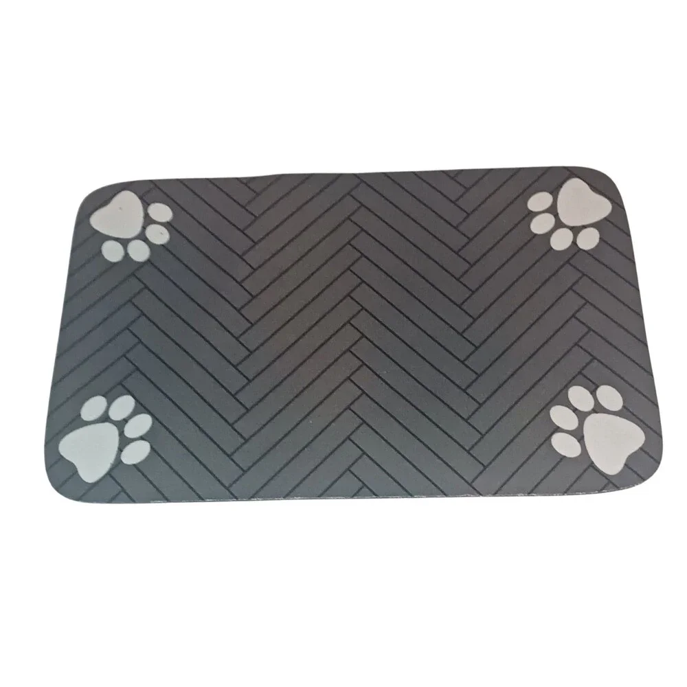 a Small feeding mat, designed to protect floors from spills and messes.